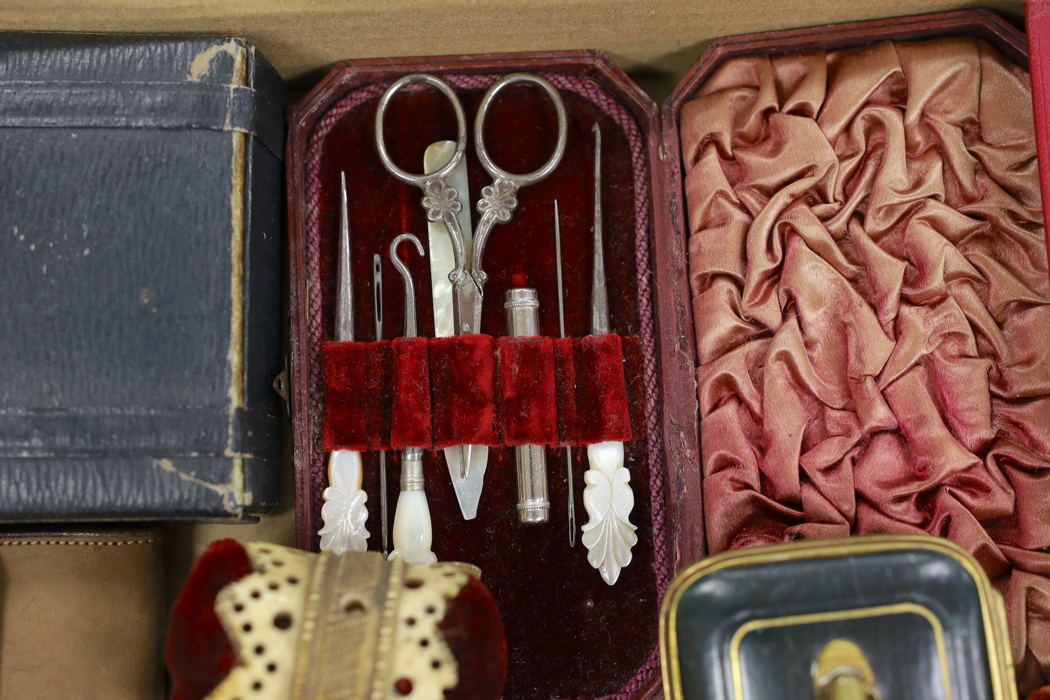 A large collection of mostly late 19th, early 20th century Morocco leather Etui a carved bone pin cushion and two miniature baskets. Largest basket 18cms wide